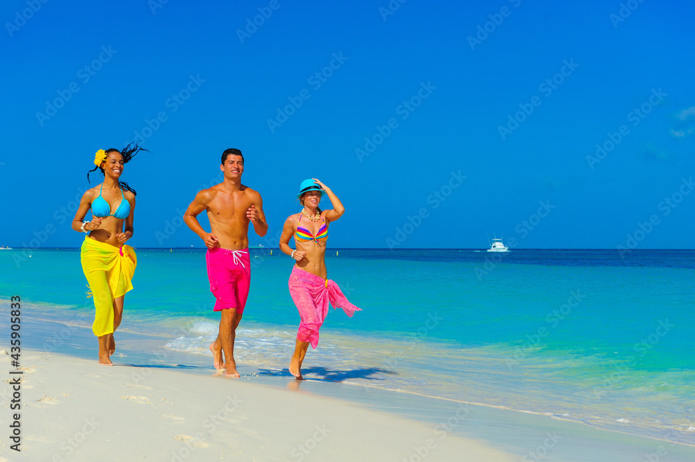 Wall mural young people at the beach playing, running on the beach, interracial, black