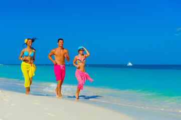 Young people at the beach playing, running on the beach, interracial, black