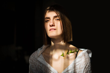 Beauty portrait of a beautiful young girl with a shadow pattern on the face and body in the form of...