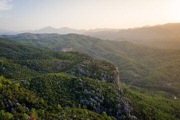 Naklejka premium Morning landscape just after sunrise. The sun's rays fall on the mountain valley. Aerial view of Canyonlands National Park near ancient city of Selge Adam Kayalar, Turkey. Koprulu Canyon.
