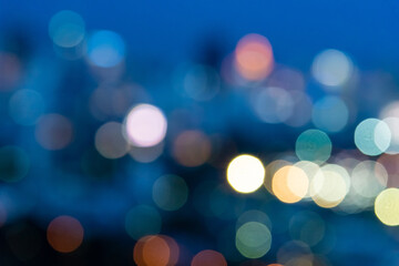 Fototapeta premium abstract blurred city lights and building with a circular bokeh on blue background. 