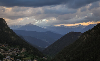 beautiful village among the mountains and green forests under a cloudy sky