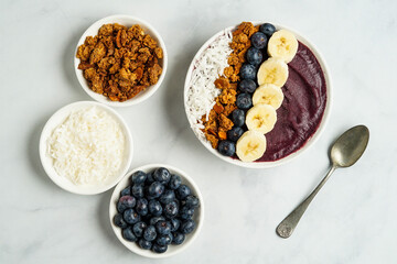 Blueberry smoothie bowl with granola and fresh fruit