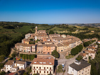 Naklejka premium Italy, May 2021. Aerial view of the medieval village of Serrungarina in the province of Pesaro and Urbino in the Marche region. You can also see the green hills around.