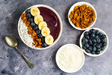 Blueberry smoothie bowl with granola and fresh fruit