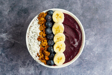 Blueberry smoothie bowl with granola and fresh fruit