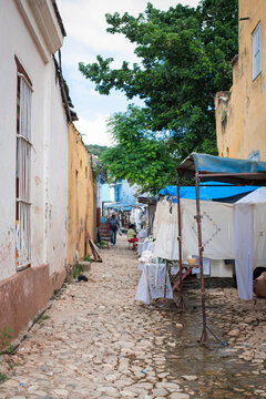 narrow street market selling cuban souvenirs and local crafts on the streets of trinidad