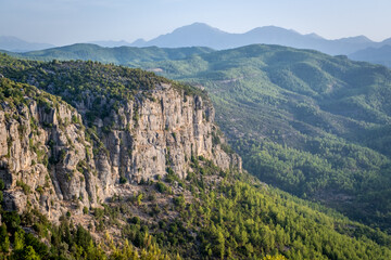 Naklejka premium Morning landscape just after sunrise. The sun's rays fall on the mountain valley. Aerial view of Canyonlands National Park near ancient city of Selge Adam Kayalar, Turkey. Koprulu Canyon.