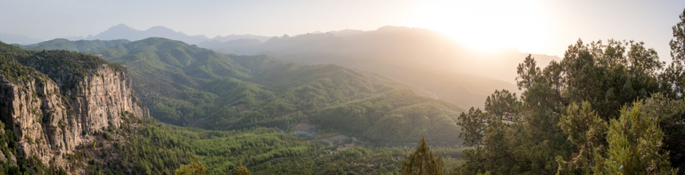 Morning landscape just after sunrise. The sun's rays fall on the mountain valley. Aerial view of Koprulu National Park near ancient city of Selge Adam Kayalar, Turkey. High resolution panorama