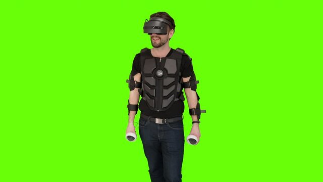 Nerdy gamer man folds down display robocop VR virtual reality production green screen gaming headset setup gear chest plate armor shooting game guy oculus quest 2 windows future sci-fi entertainment