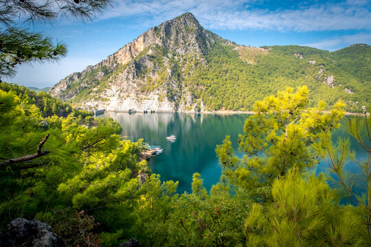 Dam lake in Green Canyon. Beatiful View to Taurus Mountains and turquoise water. Coniferous forest with bright green pine trees. Manavgat, Turkey