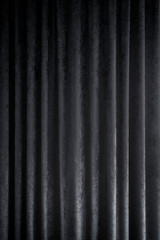 Front view of a folded dark gray curtains or drapes. Abstract high resolution full frame textured...