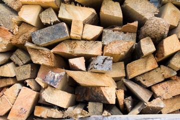 Wall firewood. Background of dry chopped firewood logs in a pile