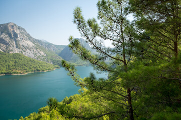 Fototapeta na wymiar Dam lake in Green Canyon. Beatiful View to Taurus Mountains and turquoise water. Coniferous forest with bright green pine trees. Manavgat, Turkey