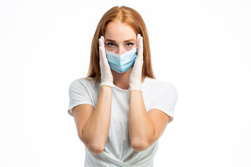 Ginger young model in gloves wearing facial mask in studio 