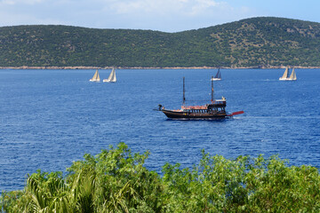 The recreation yacht with tourists is near beach of luxury hotel, Bodrum, Turkey - 435912888
