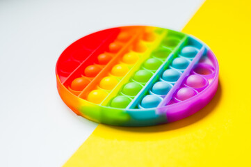 Antistress pop it toy. Rainbow sensory fidget isolated on white background. New trendy silicone toy