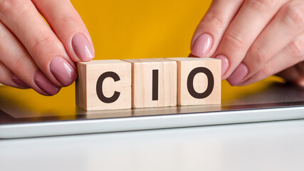 the word cio is written on wooden cubes, concept - obrazy, fototapety, plakaty