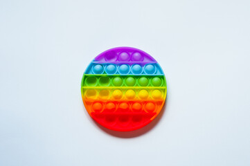 Antistress pop it toy. Rainbow sensory fidget isolated on white background. New trendy silicone toy