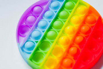 Antistress pop it toy. Rainbow sensory fidget isolated on white background. New trendy silicone toy