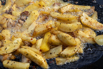 Frying large pieces of potatoes in oil
