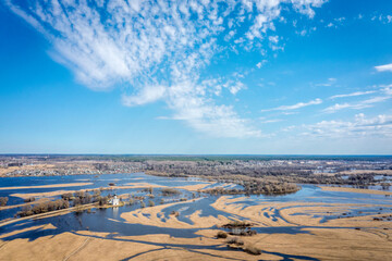 Spring flood of the river into the fields. The Church of the Intercession on the Nerl River (Pokrova na Nerli) aerial view from drone, included in the UNESCO. Golden Ring. Vladimir region, Russia.