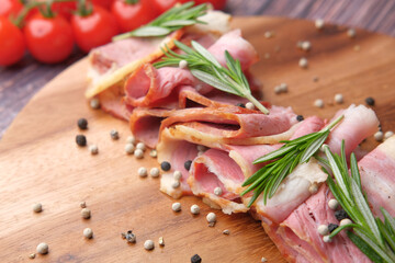Raw fed bacon strips on chopping board .