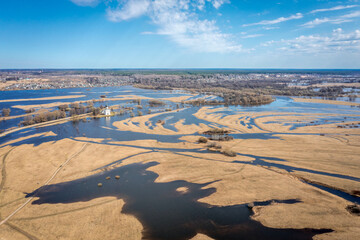 Spring flood of the river into the fields. The Church of the Intercession on the Nerl River (Pokrova na Nerli) aerial view from drone, included in the UNESCO. Golden Ring. Vladimir region, Russia.
