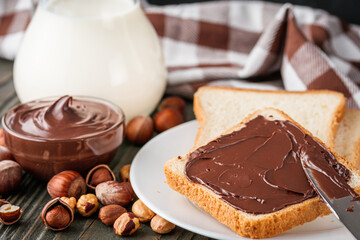 toasts with chocolate butter on a dark wooden rustic background