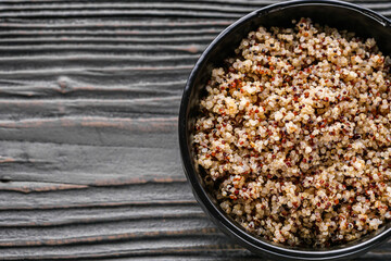 bowl of healthy quinoa on a dark wooden rustic background