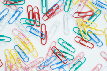 paper clips on a white background, scattered on the table