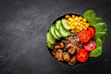 bowl of healthy quinoa with vegetables on a dark rustic background