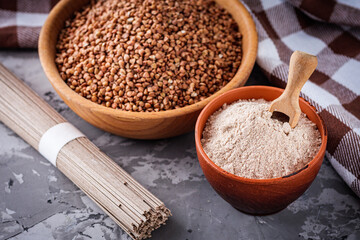 fresh natural buckwheat flour on a dark stone background culinary concept