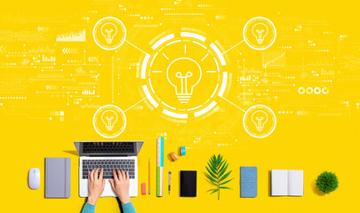 Light bulbs theme with person using a laptop