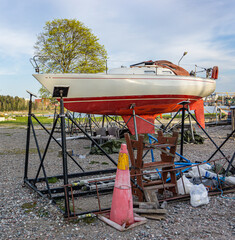 Red and white boat during reparation in harbor in small Swedish city
