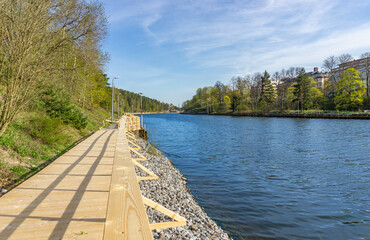 Wooden coastal promenade path by lake chanel in Sweden