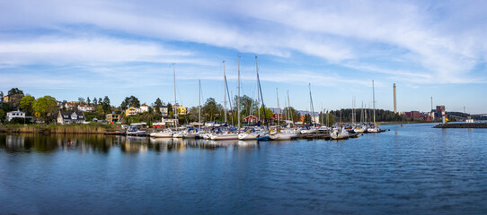 Fototapeta na wymiar Sodertalje, Sweden - May 11, 2021: Panoramic view on the harbour in Igelsta in Sodertalje with sailboats on sunny afternoon in May