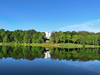 old manor house on the mirror surface of the lake