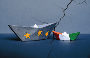 paper ship with Flags of European Union and Italy, the concept of relations between the union and...