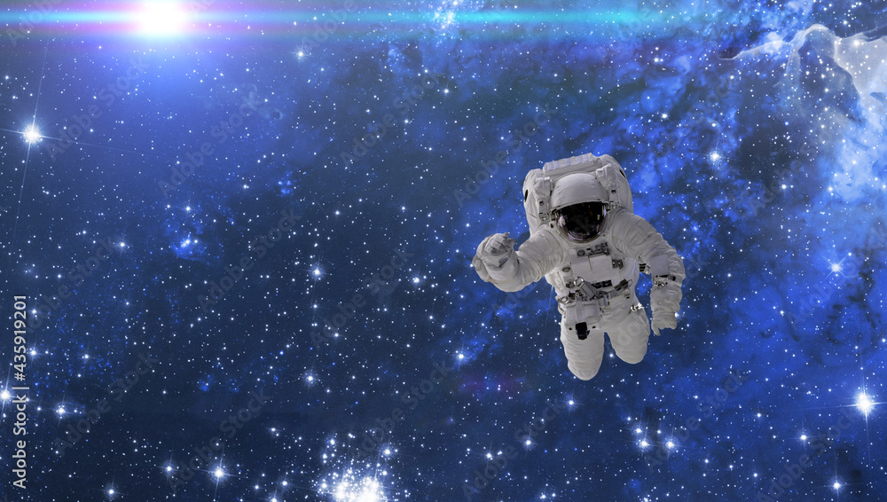 Wall mural cosmonaut fly in the outer space with stars and galaxy background with a light beam. elements of thi