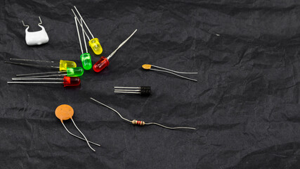 scattered electronic components on black background