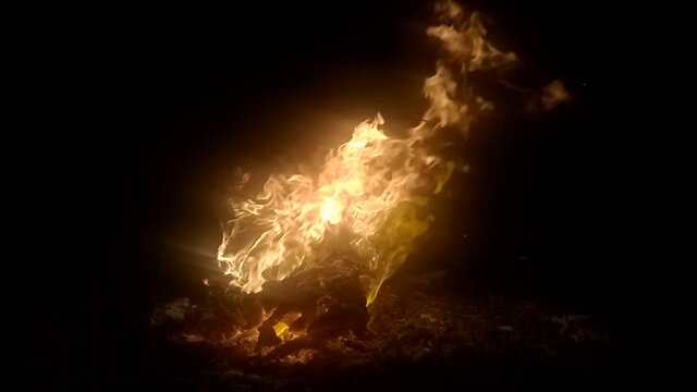 blazing hot fire burns wooden box at night