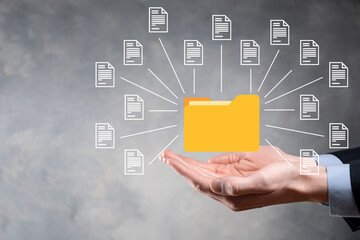 Document Management System DMS .Businessman hold folder and document icon.Software for archiving,...