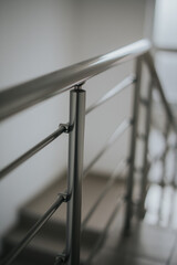 Vertical closeup shot of silver railings near stairs