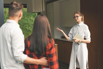 Fototapeta premium Front view of successful real estate agent making presentation of house