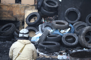The backs of people on street barricades during the struggle for freedom. Euromaidan in Kyiv,...