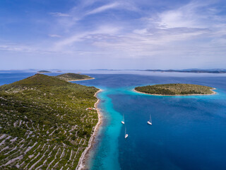 Croatian islands and sailing ships from drone view