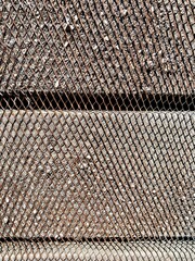 Metal wire mesh texture on wood planks.
