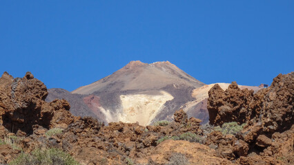 Close-up of the peak of Teide under a perfect blue sky with Roques de Garcia rock formation in foreground, Tenerife, Spain