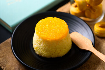 Gold egg yolk thread chiffon cake (Thai cake) on black plate